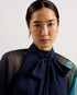 MANAMI-Dresses-The MANAMI maxi dress exudes glamour from head to toe, starting with a classic bow tie around the neck and ending with a fine pleated skirt. Floral details are printed on this piece to add an understated splash of colour, finished out with sheer bishop sleeves and a full hem to create plenty of swish. Maxi dress Large scale floral print details High neck with pussybow tie Sheer long bishop sleeves Pleated A-line skirt Front split Concealed zip fastening Chae is 5'9.5" / 1.77m and wears a Ted